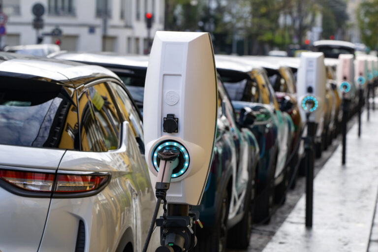 a row of electric vehicles charging